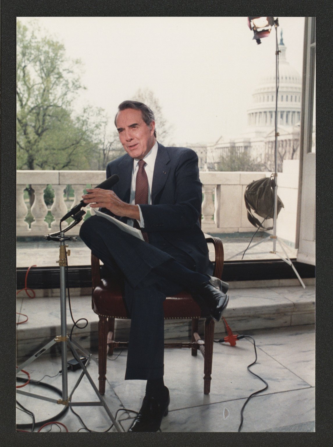 Senator Bob Dole being interviewed on balcony of U.S. Capitol, c. 1988